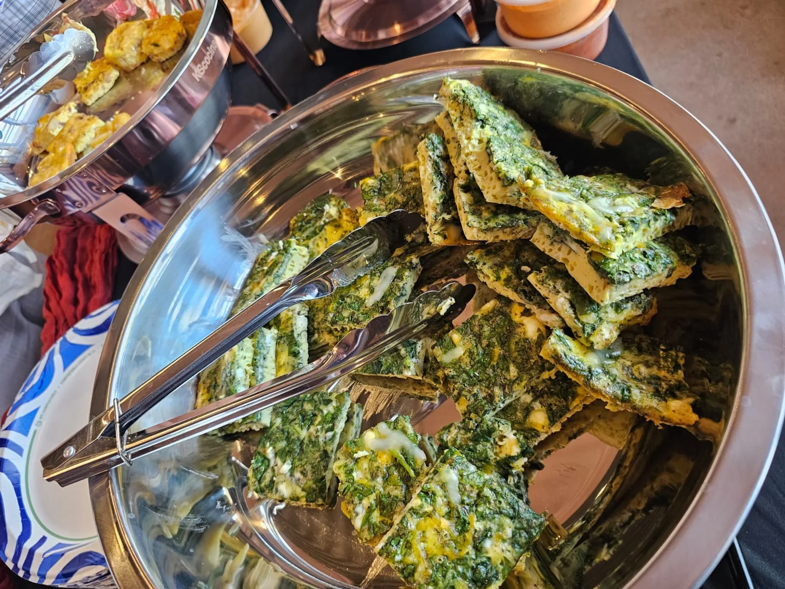 Warm spinach and feta egg bites served in stainless chafing dishes